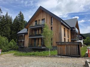 a wooden house with a gambrel roof at Dolce Vita Harrachov in Harrachov