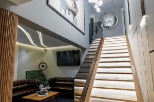 a staircase leading up to a living room with a couch at Voko by Uka Boutique Hotel in Tirana