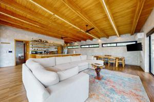 a living room with a white couch and a table at Seabird - Villa 6 in Placencia