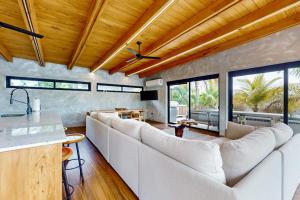 a living room with white couches and a table at Seabird - Villa 6 in Placencia