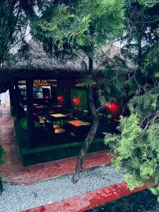 a restaurant with tables and chairs in a yard at The Carlisle Hotel LTD in Asaba