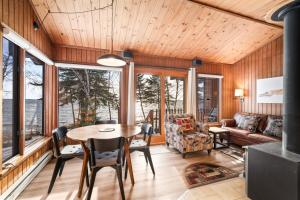 a living room with a table and chairs at Lutsen Sea Villas in Lutsen