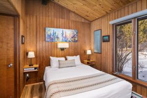 a bedroom with a large bed in a wooden wall at Lutsen Sea Villas in Lutsen +41 photos