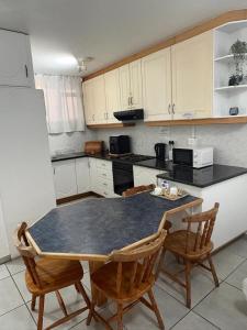 a kitchen with a table and two chairs in it at Oceans Whisper 704 beach apartment gated & Lift access in Scottburgh