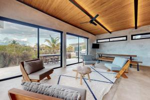 a living room with a couch and a table at Seabird - Villa 26 in Placencia