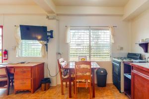 a kitchen with a table and a stove and a table and chairs at Palmetto#1 @ Island Cabanas in Caye Caulker