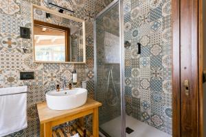 a bathroom with a sink and a shower at Capomulini Boutique Hotel in Capo Mulini +89 photos