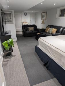 a bedroom with a bed and a living room at King Size In-Suite Basement in Toronto