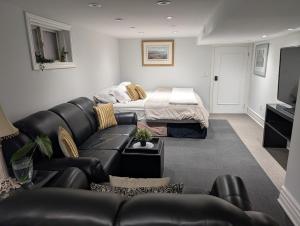 a living room with a couch and a bed at King Size In-Suite Basement in Toronto