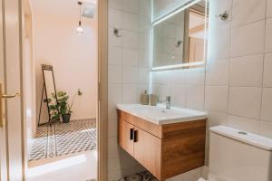 a bathroom with a sink and a toilet and a mirror at Casa Autentica 1933 in Kos +12 photos