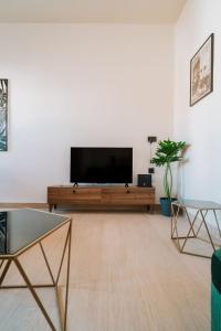 a living room with a large flat screen tv at Casa Autentica 1933 in Kos
