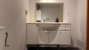 a bathroom with a sink and a mirror at Targówek Home in Warsaw +7 photos