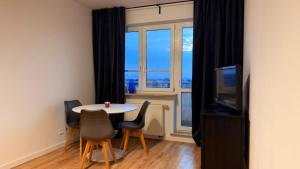 a room with a table and chairs and a window at Targówek Home in Warsaw