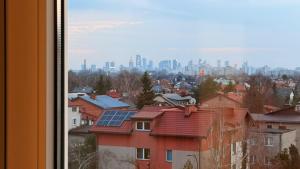 a view of a city with buildings with solar panels on roofs at Targówek Home in Warsaw