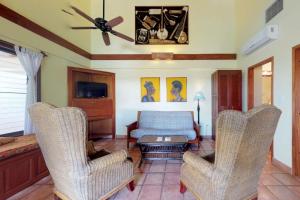 a living room with two chairs and a couch at Condo #22 @ Beachside Villas in Seine Bight Village
