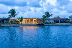 a house on the shore of a body of water at Seabird Villa 11 in Placencia