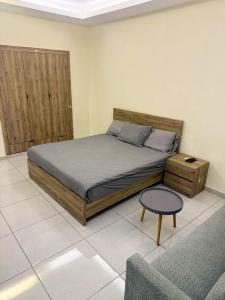 a bedroom with a bed and a table and a couch at Palm Dorms in Beirut