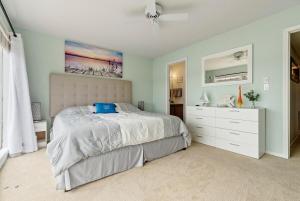a bedroom with a bed with a blue laptop on it at Baypoint Paradise in Osage Beach +31 photos