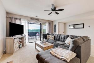 a living room with a couch and a flat screen tv at Baypoint Paradise in Osage Beach