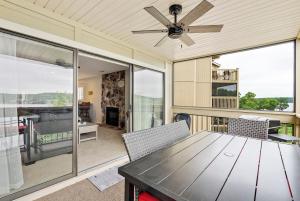 a dining room with a table and a ceiling fan at Baypoint Paradise in Osage Beach