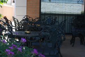 a group of black tables and chairs on a patio at Voko by Uka Boutique Hotel in Tirana