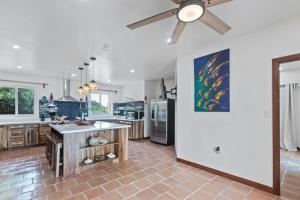 a kitchen with a ceiling fan and a counter at Casa Edie in Placencia +44 photos