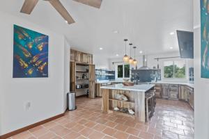 a kitchen with a large island in the middle at Casa Edie in Placencia