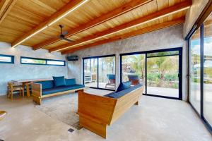 a living room with a couch and a table at Seabird - Villa 1 in Placencia