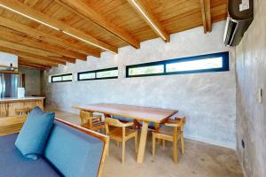 a dining room with a wooden table and chairs at Seabird - Villa 1 in Placencia +42 photos