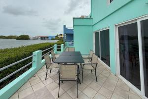 a patio with a table and chairs on a balcony at Villa 18 at Maralaguna in San Pedro +60 photos