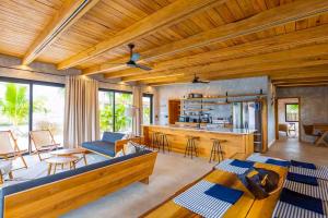a living room with a couch and a table at Seabird - Villa 10 in Placencia