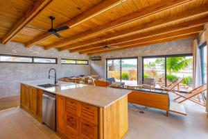 a kitchen with a large island in a room at Seabird - Villa 10 in Placencia