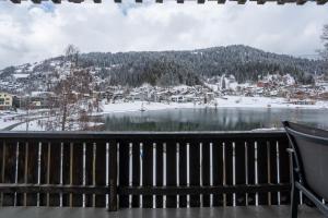 a view from the deck of a resort in the snow at La Riva mit Berg- und Seeblick in Laax