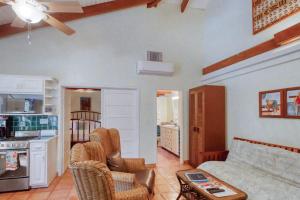 a living room with a couch and a kitchen at Condo #27 @ Beachside Villas in Seine Bight Village