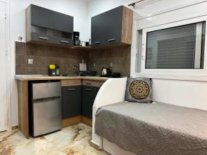 a small kitchen with a bed and a window at Bazakos Luxury Kampi Beach Studio 2 in Fournoi