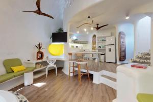 a kitchen and living room with a table and chairs at Dolphin @ Swan Villas in Maya Beach