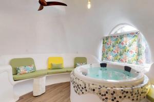 a living room with a tub and a couch at Dolphin @ Swan Villas in Maya Beach