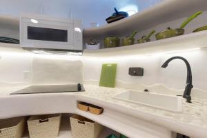 a kitchen counter with a sink and a microwave at Dolphin @ Swan Villas in Maya Beach +26 photos