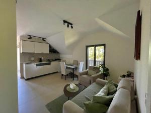 a living room with a couch and a table at Star Hill Apartments in Nova Varoš