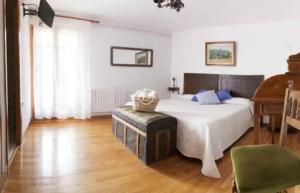 a bedroom with a large bed and a piano at Casa Peiró in Coll