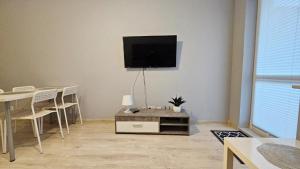 a living room with a flat screen tv on a wall at Jedenastka in Płock
