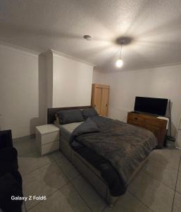 a bedroom with a bed and a ceiling fan at Nowell walk in Leeds