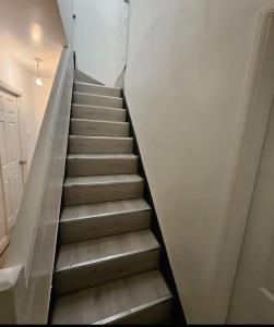 a stairway leading up to a white wall at Nowell walk in Leeds
