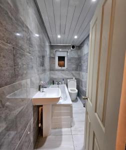 a bathroom with a sink and a tub and a toilet at Nowell walk in Leeds