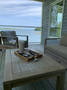 a coffee table on a deck with a view of the water at On Da Water in Lunenburg