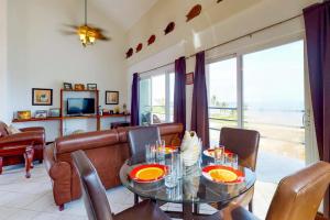 a living room with a couch and a table and chairs at Suite E303 Mara Laguna in San Pedro +35 photos