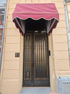 a black door with a purple canopy on a building at Ralf Residence in Bucharest
