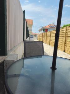 a glass table on a balcony with a fence at The Quinta & Studios in Quinta do Conde
