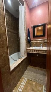 a bathroom with a tub and a sink and a mirror at Les Jardins de la Palmeraie 3 in Marrakesh +11 photos