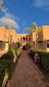 a building with a brick walkway in front at Les Jardins de la Palmeraie 3 in Marrakesh